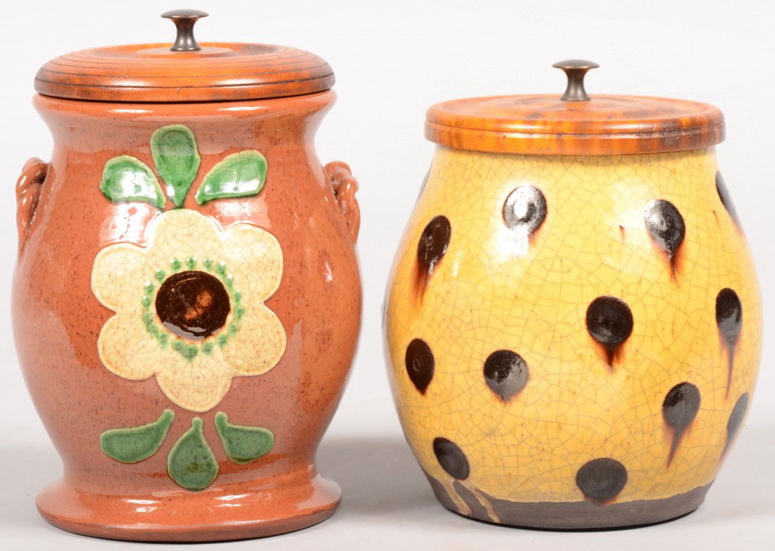 Two Turtle Creek Redware Storage Jars with Turned: Two Turtle Creek Redware Storage Jars with Turned Wood Lids. A yellow glazed jar with manganese spots with forced craquelure and a figured maple lid with metal knob. 5 1/2"h. Along with another jar an