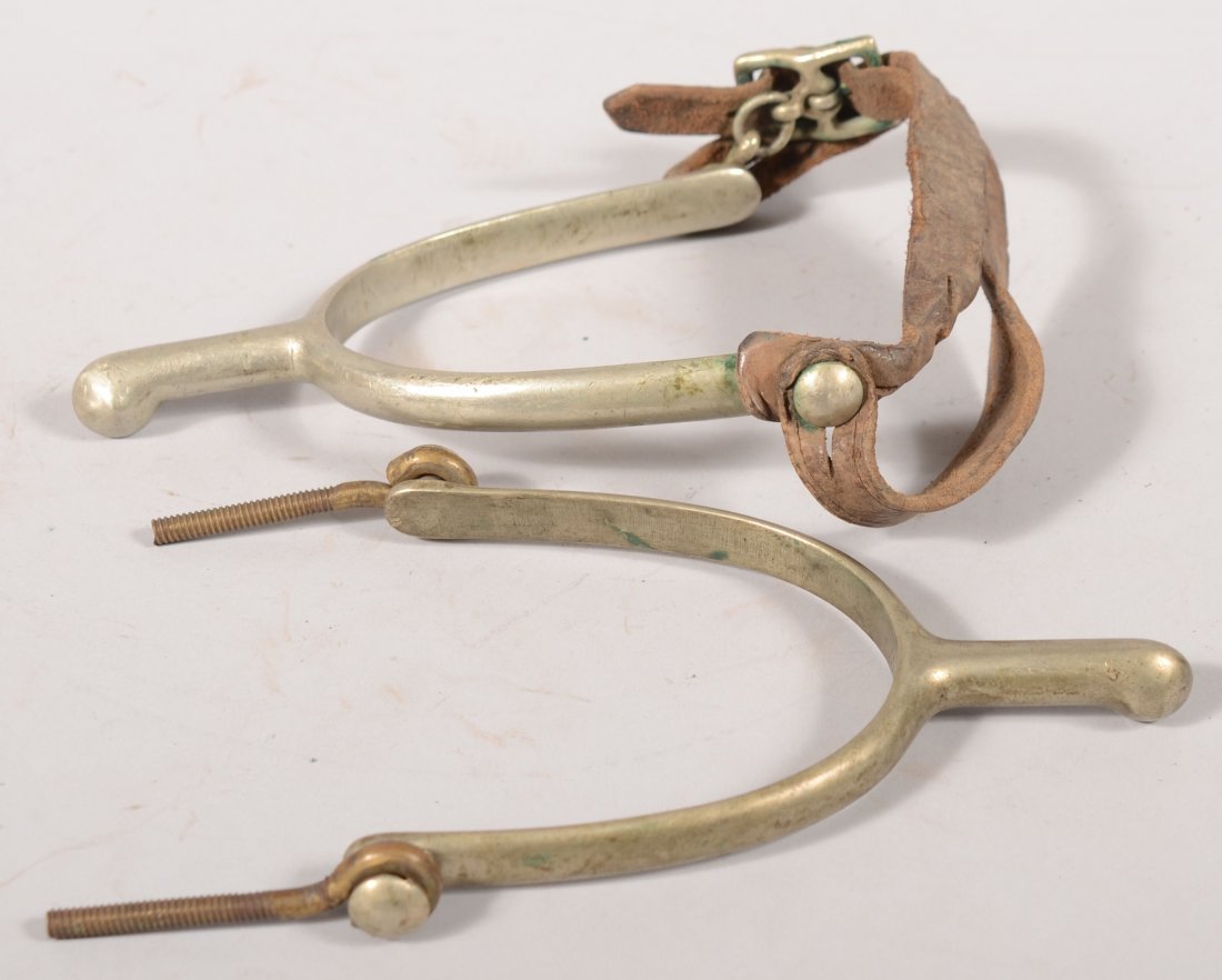 Pair of U.S. Cavalry spurs made without rowels. On: Pair of U.S. Cavalry spurs made without rowels. One strap has been replaced with brass eye bolts. Each is stamped "US" on the inside.