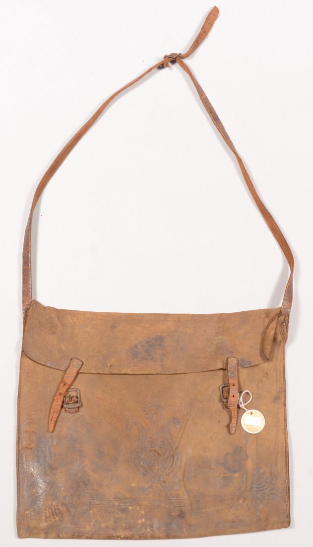 Leather pouch 14" x 11-1/2" embossed with a line b: Leather pouch 14" x 11-1/2" embossed with a line border and foliate design and having a leather shoulder strap.