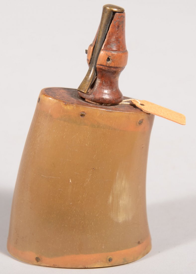 Small powder horn 4" high overall having an oval f: Small powder horn 4" high overall having an oval flat base 1-1/2" by 2-3/8" with a translucent olive body and a turned wood spout using a spring-loaded brass closure lever. Very good.