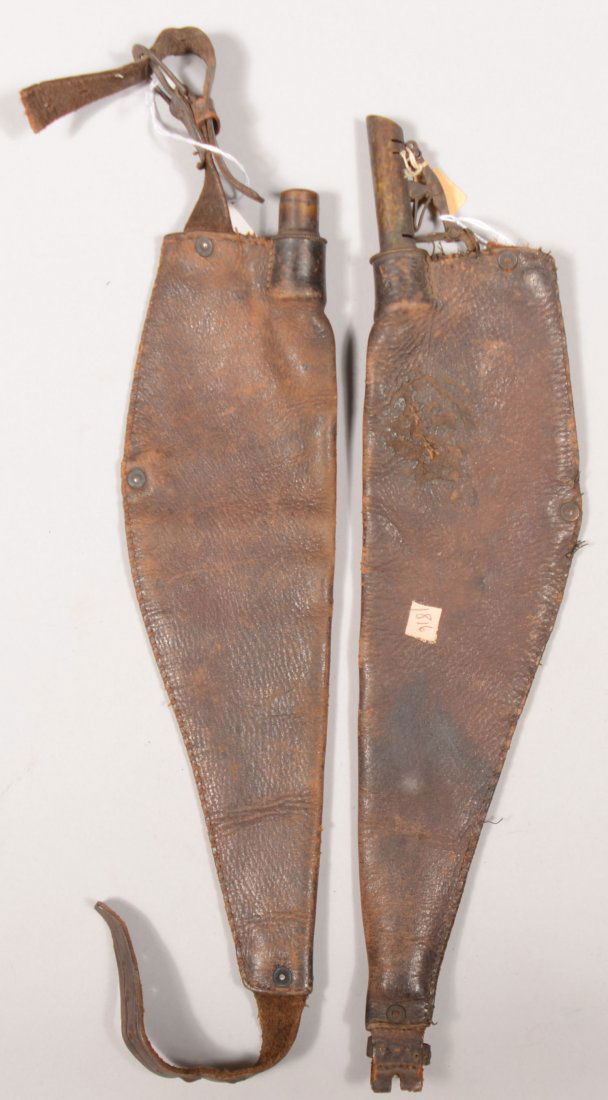 Lot of (2) leather shoulder mounted shot pouches w: Lot of (2) leather shoulder mounted shot pouches with brass chargers. Both are missing the straps, one has a brass cap replacing the charger.