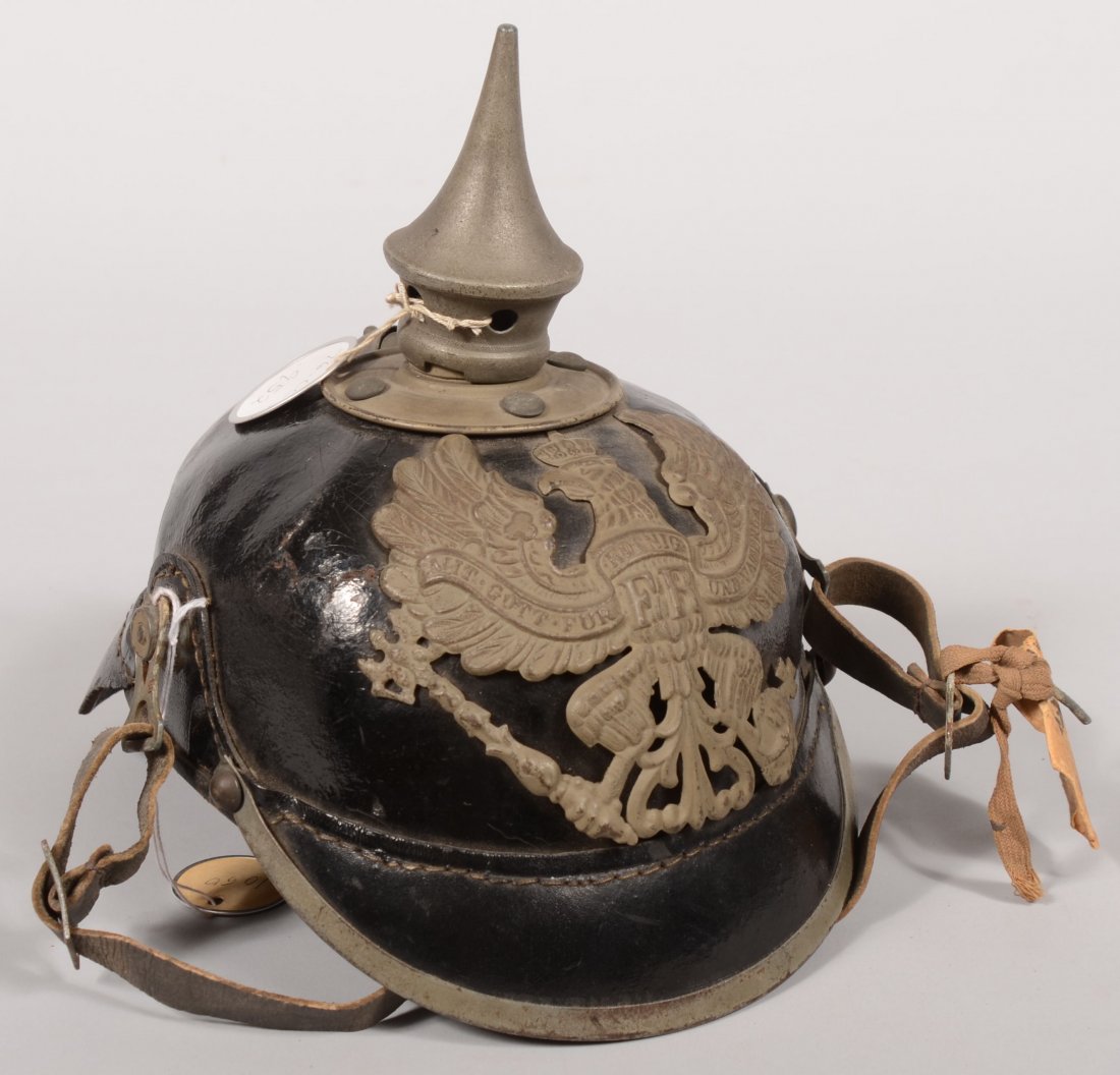 WW1 German spike helmet dated 1916 having a Prussi: WW1 German spike helmet dated 1916 having a Prussian front plate and a soldier's name written inside. It is missing the rossettes but has the leather chinstrap. Good.
