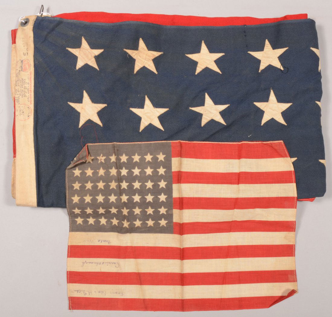 lot of (2) 48 star flags; one 5 ft. x 8 ft. with s: lot of (2) 48 star flags; one 5 ft. x 8 ft. with sewn stars and sewn stripes, the other 12 in. x 16 in. with "Carried through the World War" written on it.