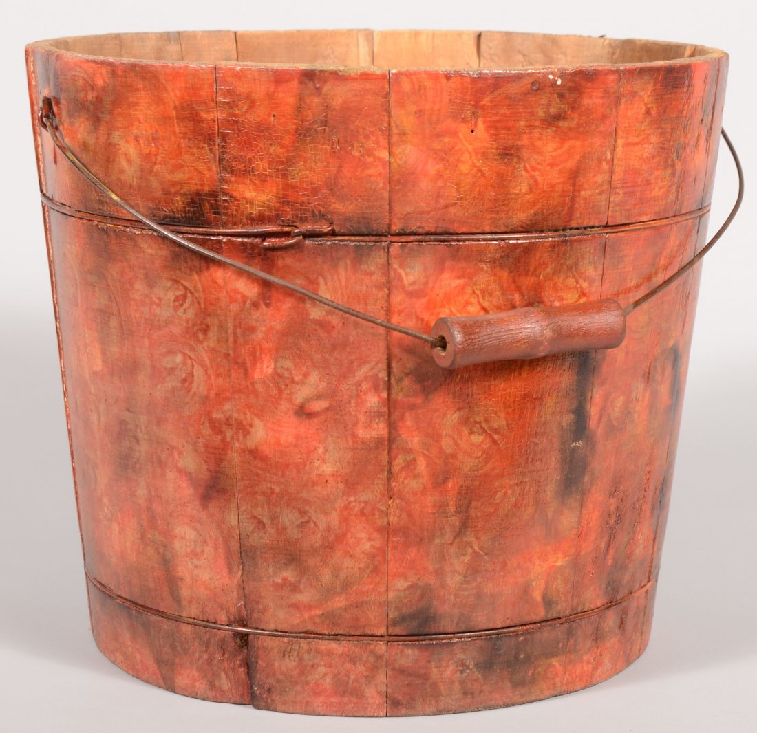 Wire Banded Staved Wood Bucket with Swirled Red Pa: Wire Banded Staved Wood Bucket with Swirled Red Paint. Tapered sides and swinging wire bail with turned wood grip. 12"h. X 13 3/4"dia. at top rim.