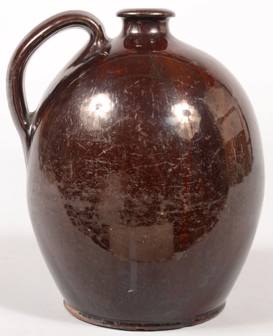 Pennsylvania 19th Century Redware Pottery Bulbous: Pennsylvania 19th Century Redware Pottery Bulbous Form Jug with flared collar spout and manganese glaze. 9 3/4"h.