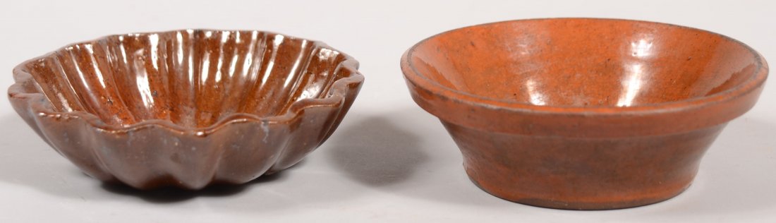 Two Pieces of Pennsylvania 19th Century Glazed Red: Two Pieces of Pennsylvania 19th Century Glazed Redware Pottery; Scalloped edge and ribbed food mold, 4 3/8" diam. And a flared edge small bowl, 4 1/2" diam.