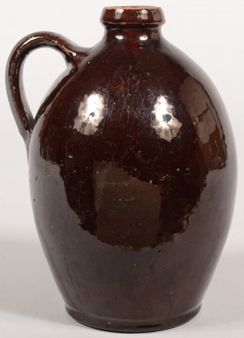 Pennsylvania 19th Century Redware Pottery Bulbous: Pennsylvania 19th Century Redware Pottery Bulbous Form Jug with collar spout and manganese glaze. 9"h.