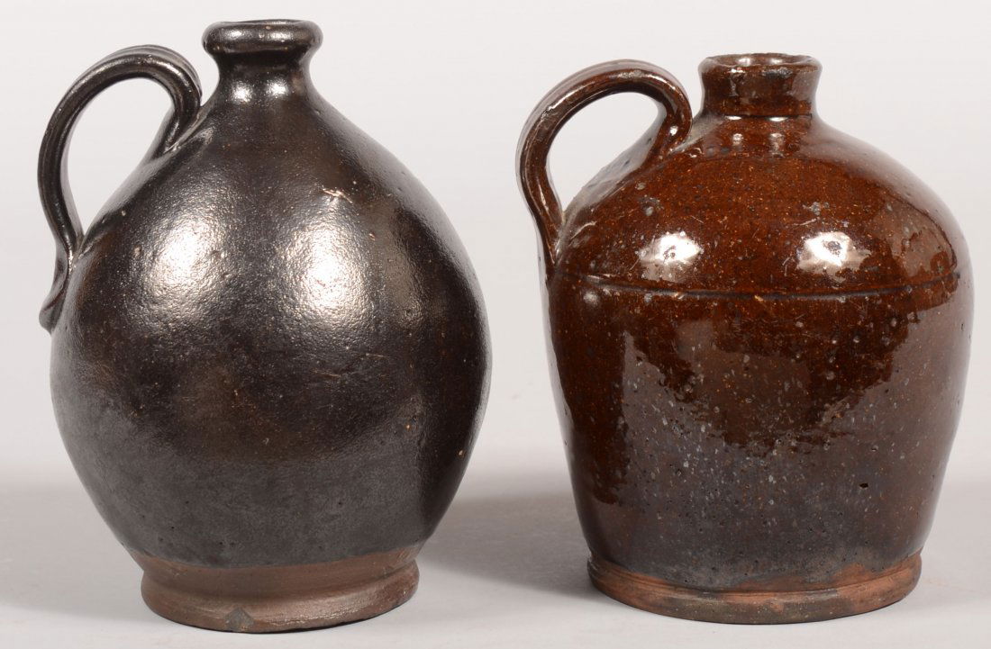Two Pennsylvania 19th Century Bulbous Form Redware: Two Pennsylvania 19th Century Bulbous Form Redware Pottery Jugs with manganese glaze and loop handles. 6 1/4" and 6 3/4"h.