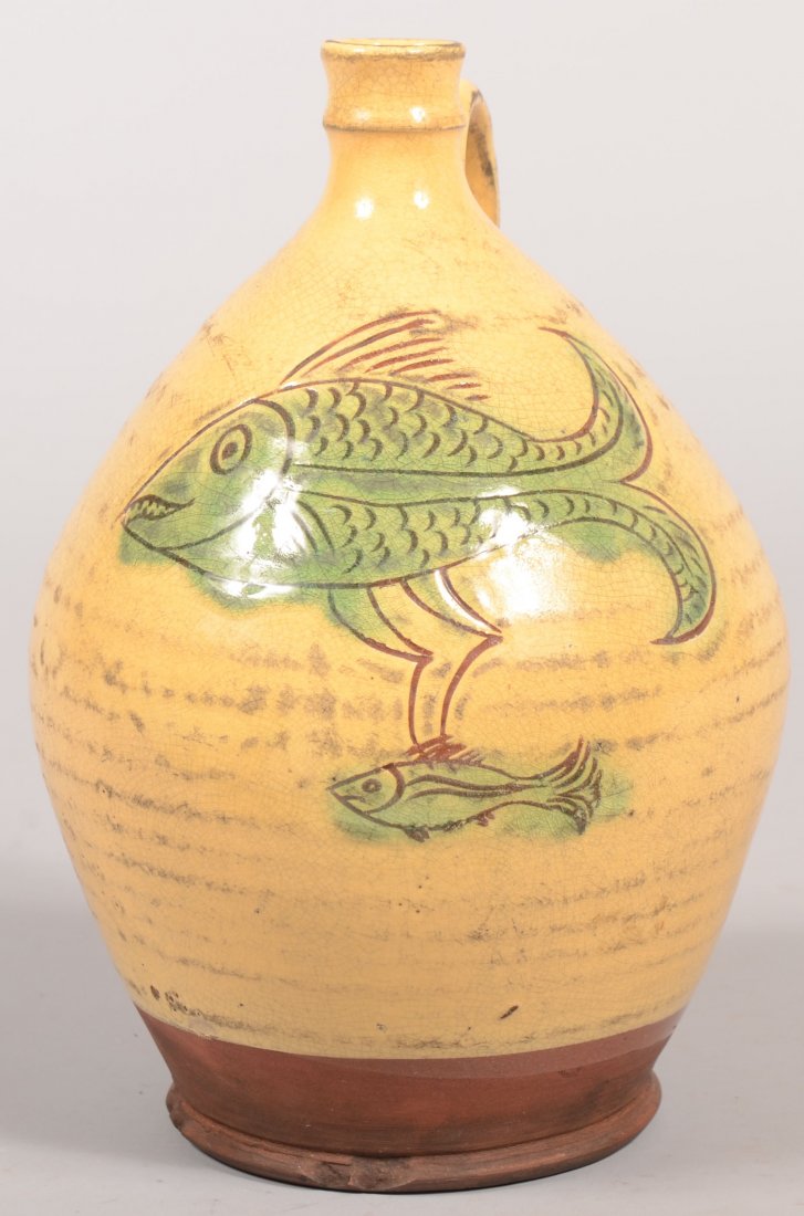 Wisconsin Pottery Sgrafitto Decorated Bulbous Form: Wisconsin Pottery Sgrafitto Decorated Bulbous Form Redware Jug. Yellow glaze with double fish design, Artist Stamped "E.A.". 9 7/8"h.