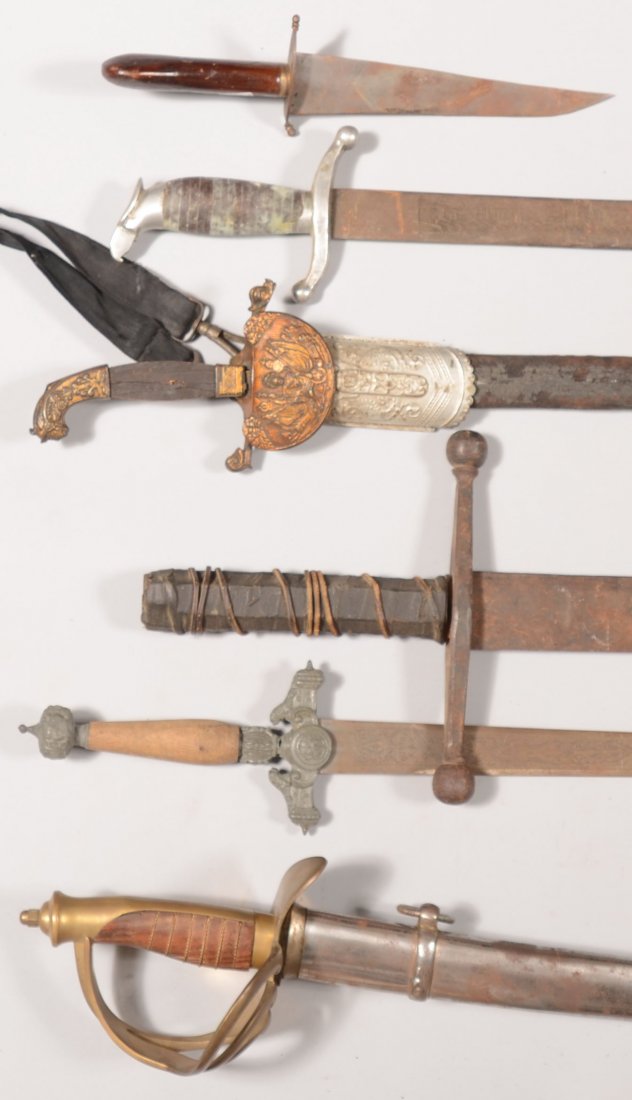 Lot of (6) reproduction edged weapons including a : Lot of (6) reproduction edged weapons including a two-handed sword possibly dating to the 19th century revival of interest in medieval armor.