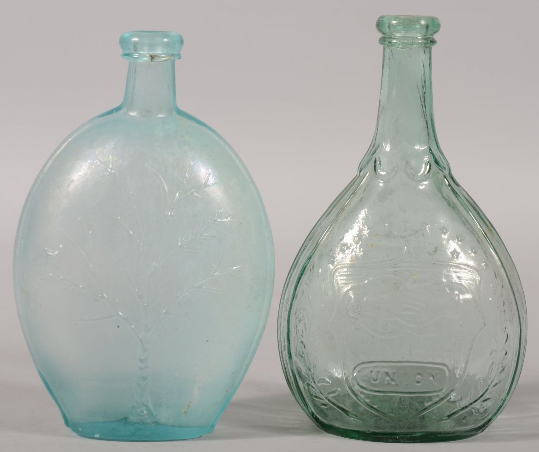 Two Early Mold Blown Glass Bottles. A blue-green r: Two Early Mold Blown Glass Bottles. A blue-green rib side ovoid flask with a Summer / Winter Tree decoration and applied blob top. 8 3/4"h. Along with a green "Union" labeled calabash bottle. One side