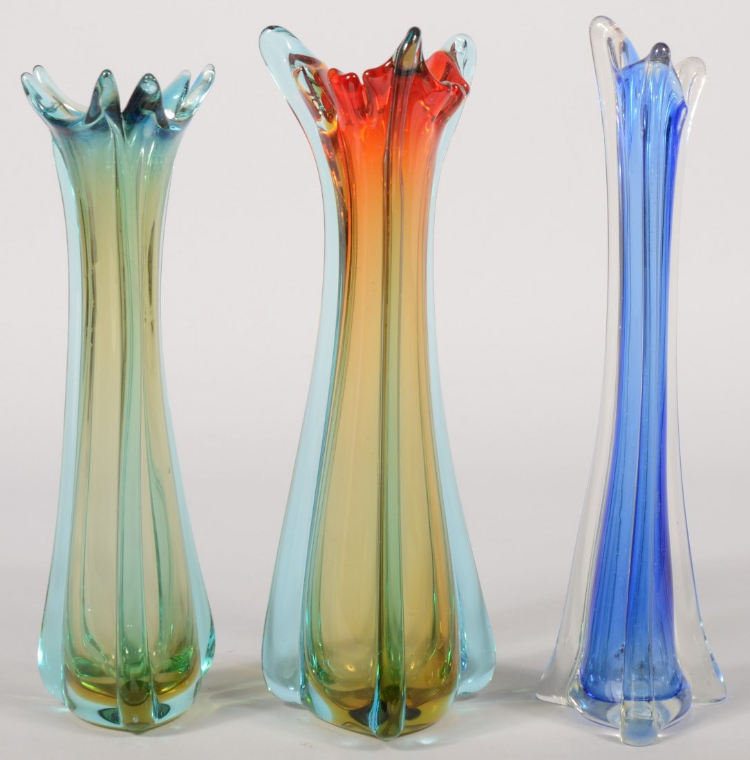Three Blown Art Glass Vases. Three sided with butt: Three Blown Art Glass Vases. Three sided with buttresses ending with a free-form mouth. Largest amber to red body with blue ribs, 13"h.; an amber body with blue ribs, 12 1/4"h.; and a blue body with c