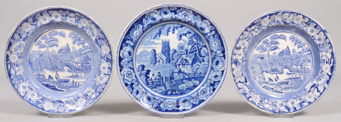 Three Blue and White Transfer Ironstone Plates. Tw: Three Blue and White Transfer Ironstone Plates. Two of same pattern titled: "Wild Rose" which is the border of a group of buildings with a bridge and fishermen. 9 1/4"dia. Along with another similar p