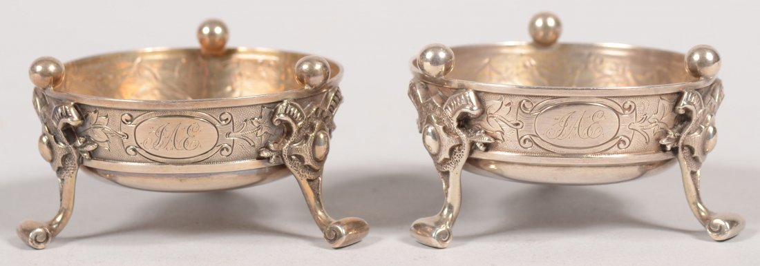 Pair of Silver Eastlake Style Salts. Three stylize: Pair of Silver Eastlake Style Salts. Three stylized and scrolled foot legs attached to round bottom tub sided bowls with leaf designs and rim balls. Marked on bottoms with left and right facing Lions 
