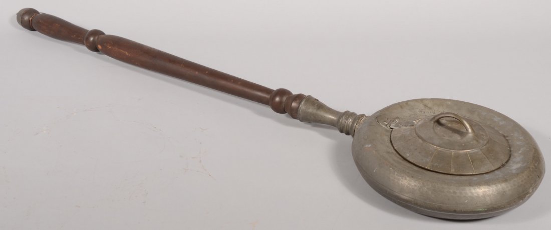 English Pewter Bed Pan or Warmer. Turned mahogany: English Pewter Bed Pan or Warmer. Turned mahogany handle with pewter cap. Faceted cover with fish tail hinge and loop handle. Double hallmarks on bottom of crown over a king's rose and "LONDON." Pan: