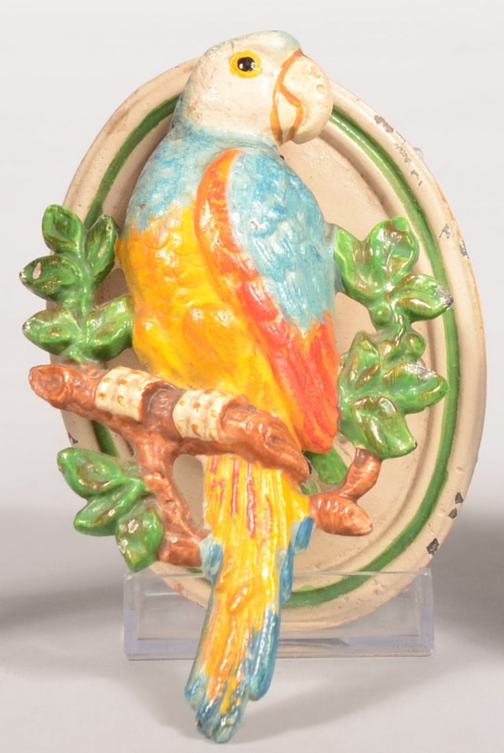 Hubley (Lancaster, PA) Cast Iron Parrot Door Knock: Hubley (Lancaster, PA) Cast Iron Parrot Door Knocker. Original paint decorated parrot door knocker on wreath perch with oval back plate, 4 5/8"h.