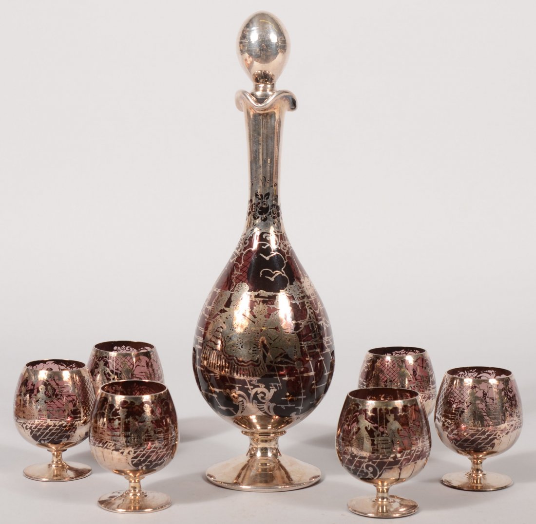 Silver Decorated Amethyst Glass Cordial Set. Conti: Silver Decorated Amethyst Glass Cordial Set. Continental. Tall blown glass ewer with silver appliqué to stopper, neck, body and foot. Body design shows a colonial dressed couple in Venice with additi