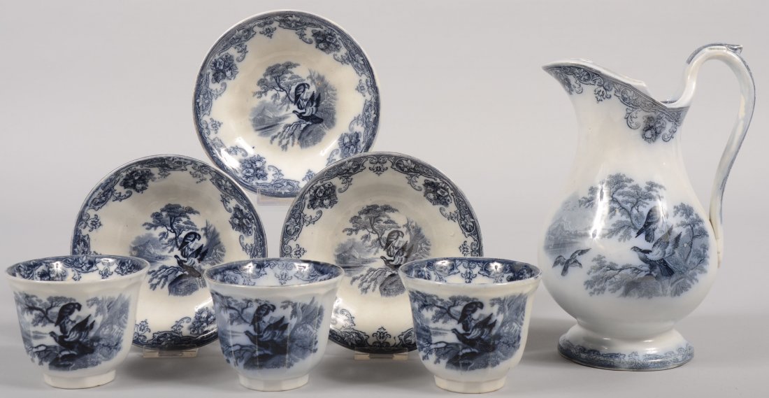 Seven Pieces of Blue Transfer Ironstone Dinnerware: Seven Pieces of Blue Transfer Ironstone Dinnerware. Three twelve sided handless cups with saucers marked on bottom: "Pearl Stoneware, Eagle, P. W. & Co.", 6"dia. X 3 1/2"h. Along with a matching bulbo