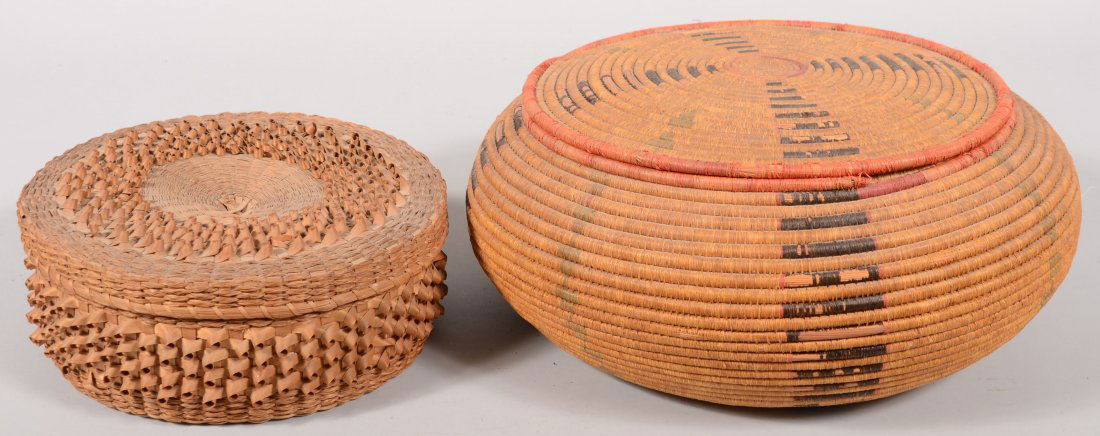 Two American Indian Baskets: Circular split and g: Two American Indian Baskets: Circular split and grass woven covered basket, 4 1/2"h. X 11"dia. And a grass wrapped and coiled circular basket with cover with naturally dyed red and black wraps.7 1/2"h