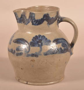 Unsigned Stoneware Squat Bulbous-Form Pitcher.: Unsigned Stoneware Squat Bulbous-Form Pitcher. With bold cobalt floral and foliate decoration. 9"h.