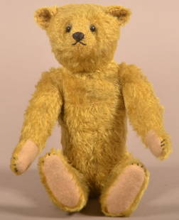 Antique Steiff Golden Mohair Teddy Bear.: Antique Steiff Golden Mohair Teddy Bear. Unsigned, early 20th century. Shoe button eyes, humpback, jointed body and felt paws. 10"h.