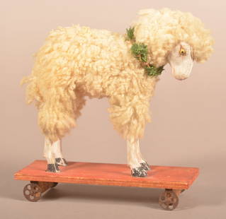 Antique Unsigned German Stick-Leg Sheep Pull Toy.: Antique Unsigned German Stick-Leg Sheep Pull Toy. Composition head, cotton body and red stained pine platform with metal wheels. 7"h. x 6-1/2"l.