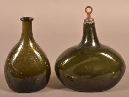 Two 18th C. Dark Emerald Green Blown Glass Bottles.: Two 18th Century Dark Emerald Green Blown Glass Chestnut Bottles. One with rare locking stopper.