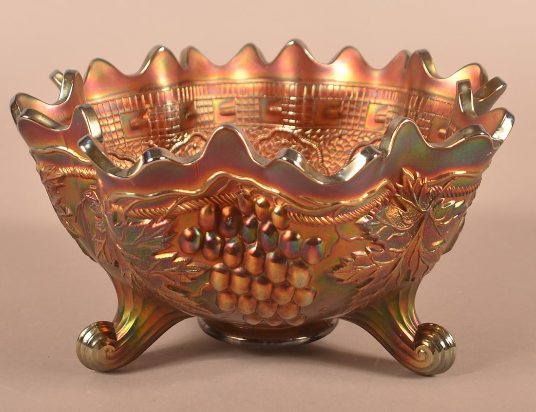 Fenton Amethyst Carnival Glass Footed Center Bowl.: Fenton Amethyst Carnival Glass Footed Center Bowl. Persian Medallion interior and grape and cable exterior. 5-1/2"h. x 10" diam.