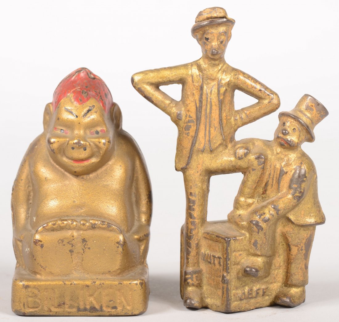 Two Character Still Banks. Mutt and Jeff gold paint: Two Character Still Banks. Mutt and Jeff gold painted cast iron still bank produced by A. C. Williams. 4 1/4"h. X 3 1/2"w. Together with a cast iron "Billiken" seated Buddha type still bank in gold pa