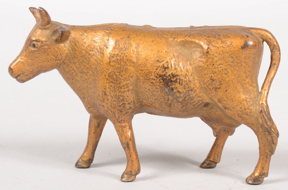 Cow Still Bank with Textured Sides. Gold painted ca: Cow Still Bank with Textured Sides. Gold painted cast iron with tail on left rear leg. A. C. Williams maker. 3 3/8"h. X 5 1/4"l.