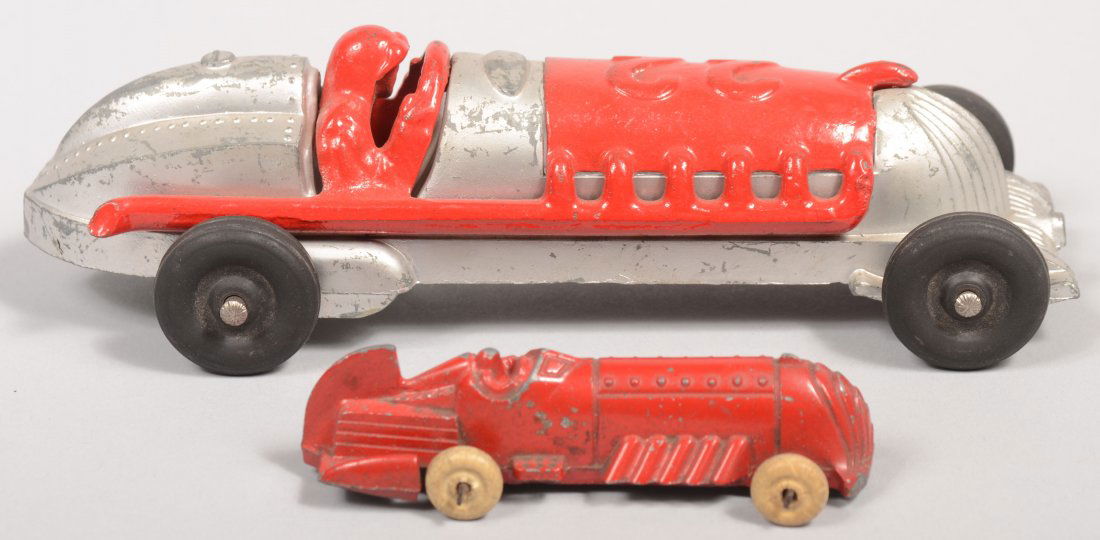 Two Hubley Race Cars. A silver pot metal and red ca: Two Hubley Race Cars. A silver pot metal and red cast iron #22 racer with driver and black rubber tires. 7 1/2"l. Along with a small red painted pot metal racer with white tires by Hubley. 3 11/16"l.