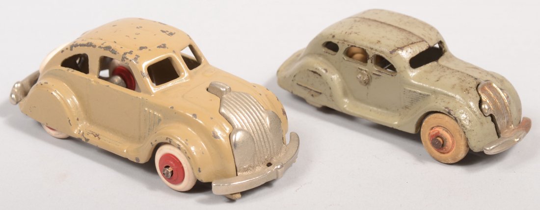 Two Cast Iron Chrysler Toy Cars. A Hubley Air Flow : Two Cast Iron Chrysler Toy Cars. A Hubley Air Flow painted taupe with nickel plated one piece chassis and red wheels with white rubber tires. 4 1/2"l. Along with an Arcade DeSoto in light gray with pl