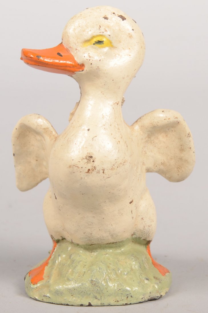 Hubley Flapping Duck Still Bank. Cast iron painted: Hubley Flapping Duck Still Bank. Cast iron painted white with orange bill and feet on green base. No trap. 5 3/16"h.