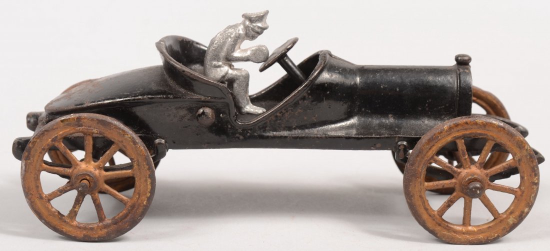 Cast Iron Open Roadster Racer. Maker unknown. Car: Cast Iron Open Roadster Racer. Maker unknown. Car has a sloping boat tail, open cockpit, leaf springs and steering wheel all painted black with large yellow painted cast spoke wheels. Includes reprodu