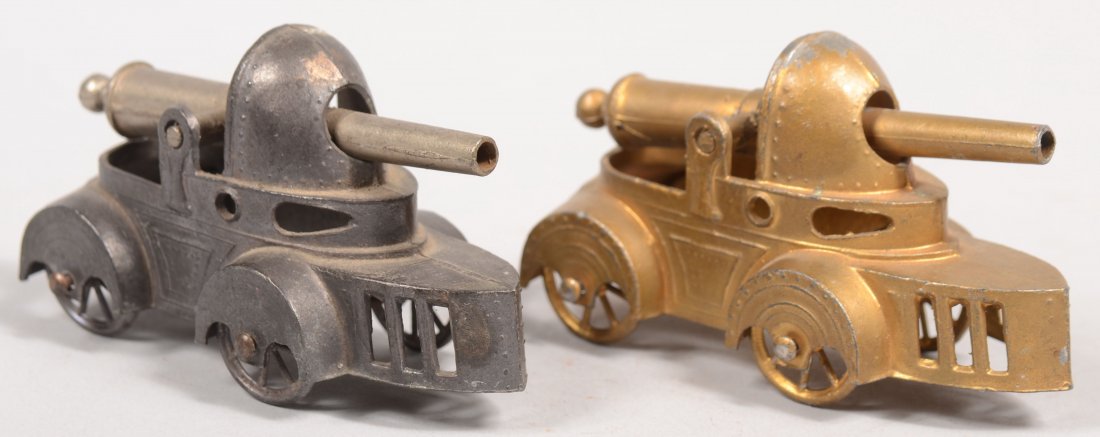 Two Cast Metal Armored Mobile Field Guns. Marked: : Two Cast Metal Armored Mobile Field Guns. Marked: "France." One natural the other painted gold. Both guns are spring loaded for firing projectiles. Each vehicle supported by four spoked wheels. 1 15/1