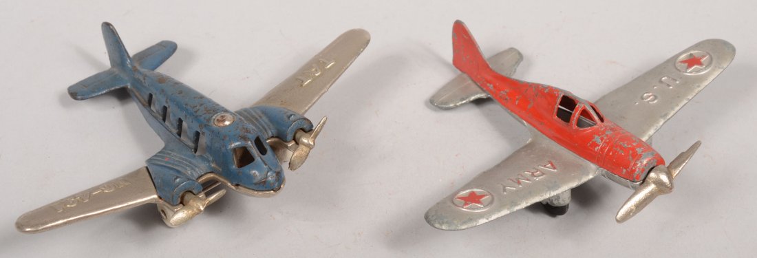 Two Hubley Painted Airplanes. A 2 piece cast iron : Two Hubley Painted Airplanes. A 2 piece cast iron twin engine passenger plane with blue fuselage and plated wings, props and undercarriage with two white rubber wheels and marked: "TAT, NC-431" on win