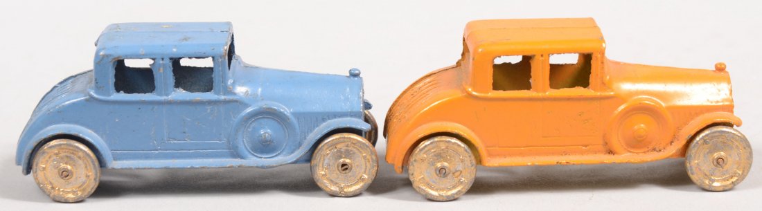 Two Tootsietoy Model 4636 (Packard) Coupes. A blue: Two Tootsietoy Model 4636 (Packard) Coupes. A blue model with gold colored cast wheels with a yellow model with gold cast wheels. 1 3/8"h. X 3"l.