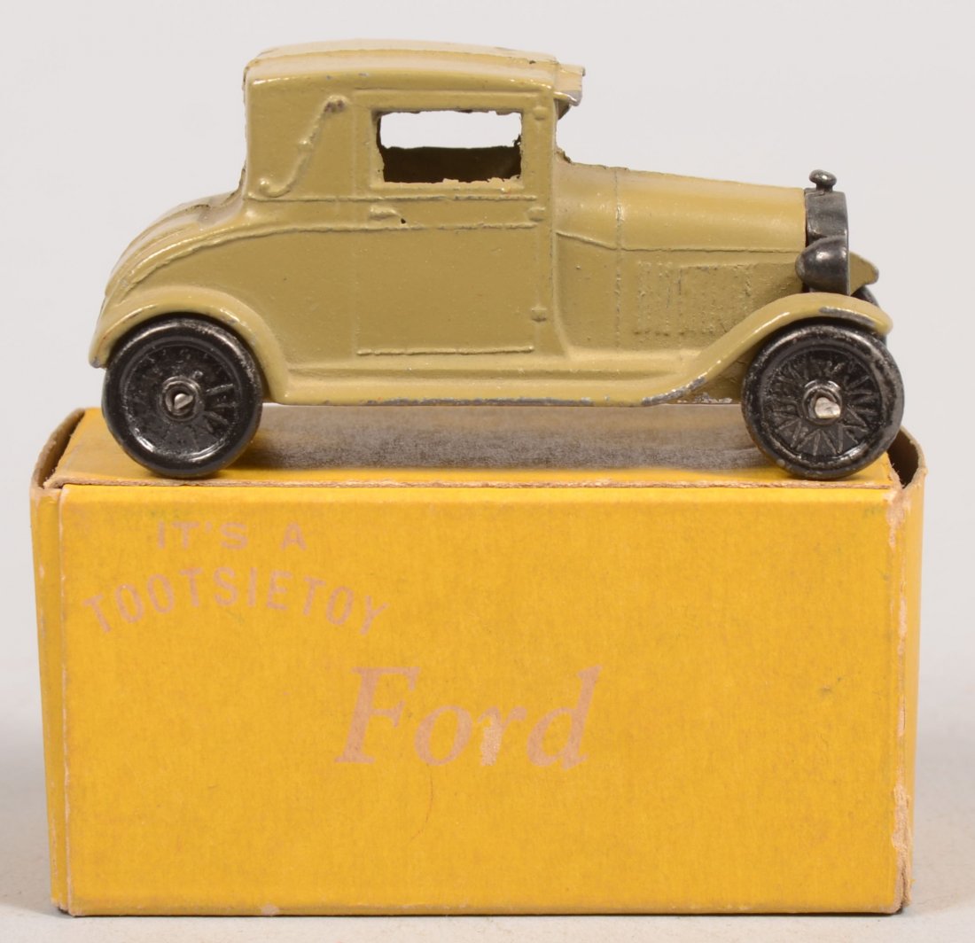 Green Tootsietoy Model A Ford Coupe with Yellow Bo: Green Tootsietoy Model A Ford Coupe with Yellow Box. Model 4655 with black cast wheels and radiator. 1 5/16"h. X 2 9/16"l.