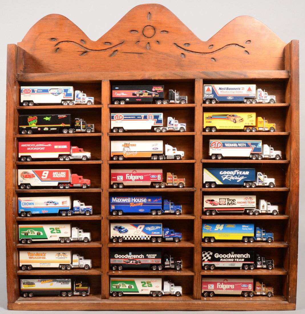 Twenty Four Matchbox Miniature Race Car Haulers in: Twenty Four Matchbox Miniature Race Car Haulers in Display Case. Twenty Kenworth truck tractors and four Mack. Matchbox Low Bed trailers represent sponsers and drivers including: STP-R. Petty; Mello Y