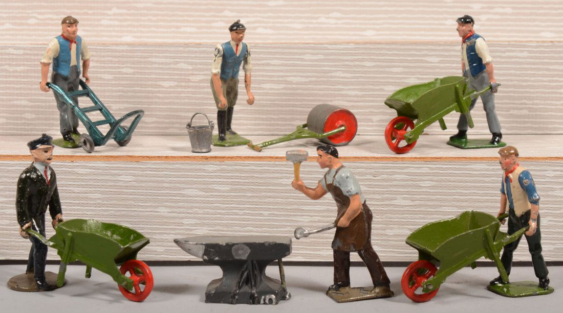 Six Painted Pot Metal Figures with Tools. Standard: Six Painted Pot Metal Figures with Tools. Standard gauge, 2 1/8"h., including: three green wheelbarrows with laborers; a railway worker with hand truck; a blacksmith with anvil; a laborer with swingin