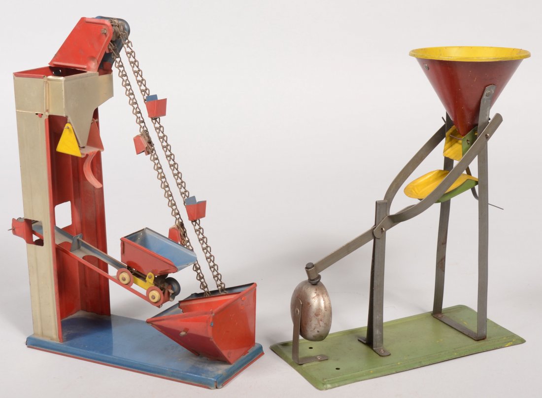 Two Painted Tin Action Sand Toys. Crank operated, : Two Painted Tin Action Sand Toys. Crank operated, chain driven conveyer with two collection hoppers and weight balanced car with dumping hopper. Marked: "Ohio Art Co., Bryan. Ohio." 10 5/8"h. X 7 3/4"