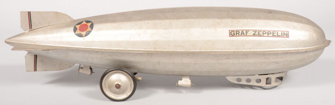 Silver Pressed Steel "Graf Zeppelin" Riding Toy. D: Silver Pressed Steel "Graf Zeppelin" Riding Toy. Decal on nose for: "Steelcraft, Murray Ohio Mfg. Co." Two pressed steel rear wheels with black rubber tires and a steel caster wheel at front inside go