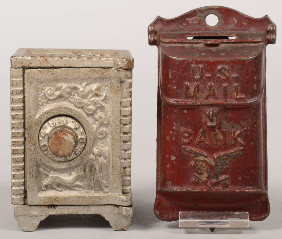 Two Painted Cast Iron Still Banks. An unknown safe: Two Painted Cast Iron Still Banks. An unknown safe type in silver paint with two ring dial combination lock. Top of back features a bas-relief of the Angel Gabriel and door has a man with dog. Top, bo
