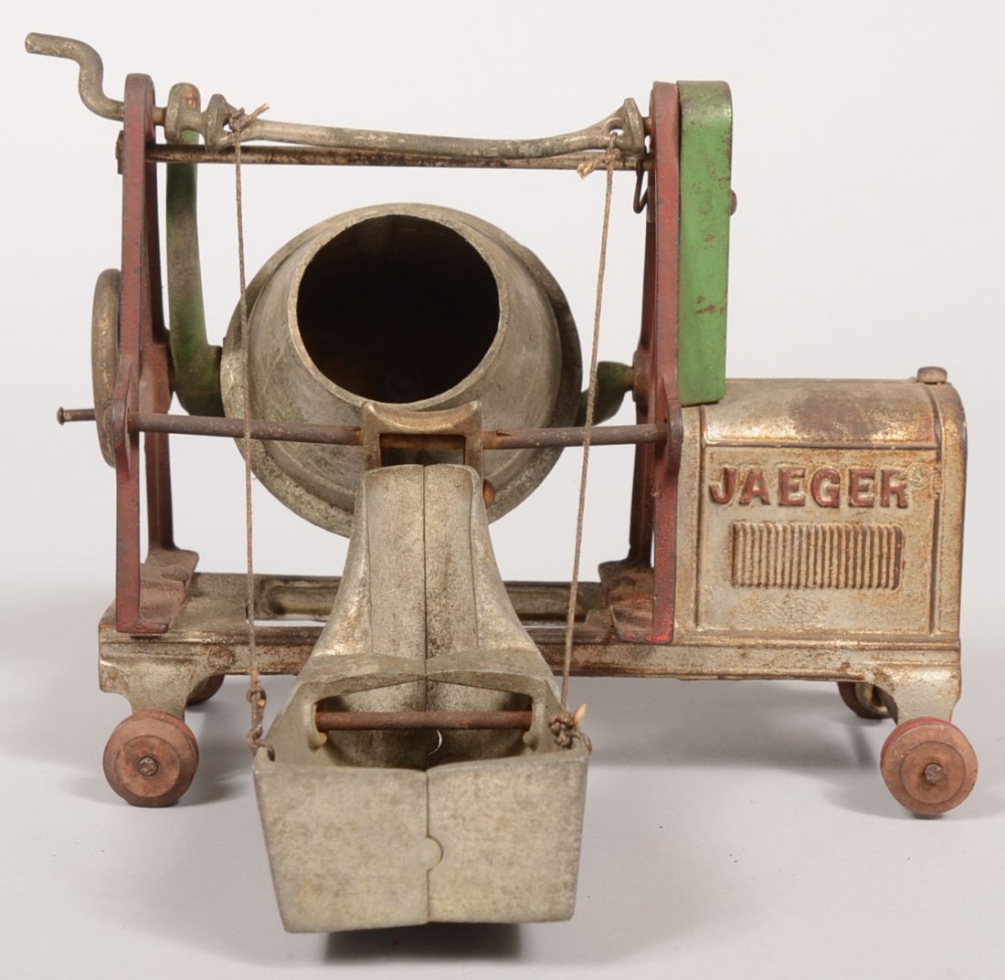 Jaeger Cement Mixer by Kenton. Cast iron toy paint: Jaeger Cement Mixer by Kenton. Cast iron toy painted silver with green and red accents. Original red wooden wheel hubs remain. 7"h. X 9"l. X 8 1/4"w.