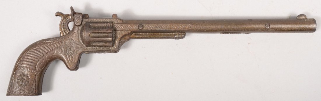 Kenton "Buffalo Bill" Long Barrel Cap Pistol. "Ned: Kenton "Buffalo Bill" Long Barrel Cap Pistol. "Ned Buntline" long barrel revolver style pistol. First model by Kenton produced in 1925. 11 3/8"l.