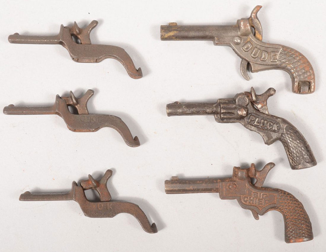 Six Small Cast Iron Single Shot Cap Pistols. "Big: Six Small Cast Iron Single Shot Cap Pistols. "Big Chief", 1930, Dent, 3 1/2"l.; "Dude", 1887, Stevens, 3 1/2"l.; "Pluck", 1930, Stevens, 3 1/2"l.; and three "OK, Patd. June 17, 1898, 3 1/2"l.