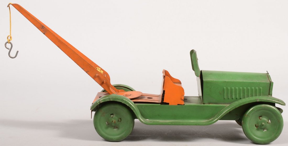 Neff Moon Pressed Steel Open Cab Wrecker. Unmarked: Neff Moon Pressed Steel Open Cab Wrecker. Unmarked. Green body and wheels with orange seat and gantry on open bed. Truck: 11 7/8"l. with gantry: 17"l. X 8 1/2"h.