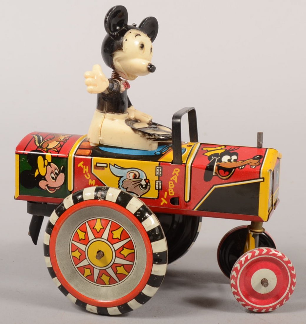 Marx Toy Company Mickey Mouse Whoopie Car. Plastic: Marx Toy Company Mickey Mouse Whoopie Car. Plastic Mickey figure mounted on top of polychrome lithograph decorated tin car that gyrates, spins and bucks when wound. 6 1/4"h. X 5 3/4"l.