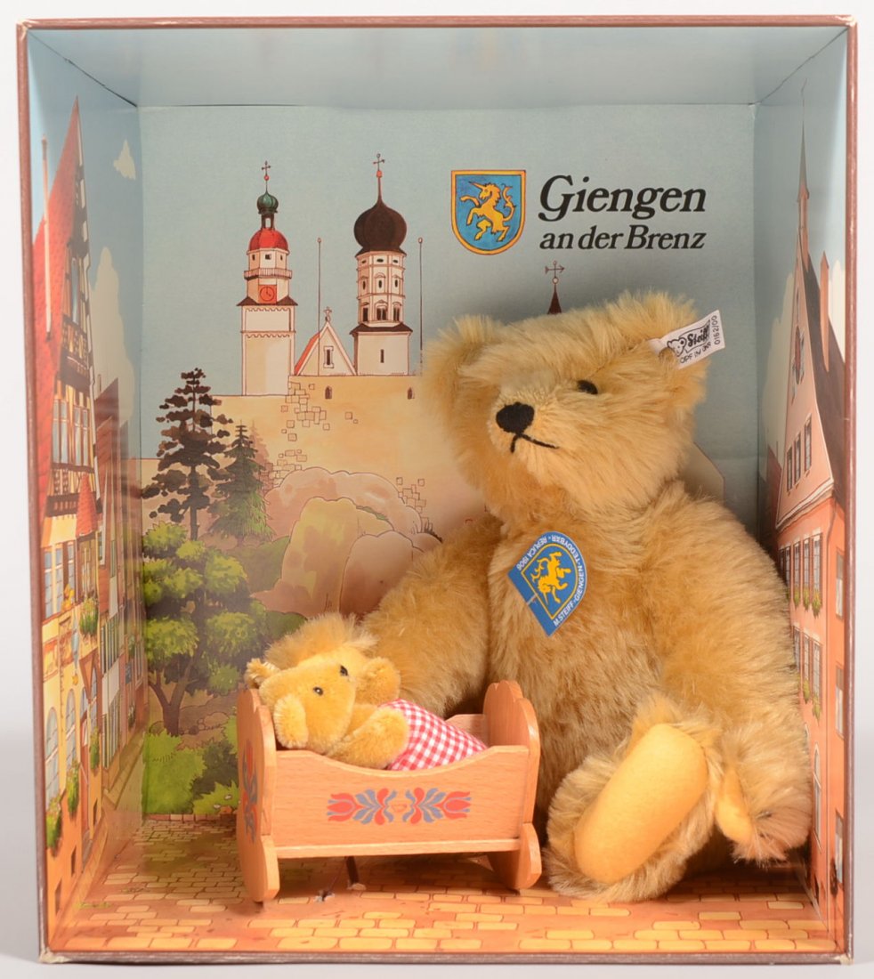 Steiff Teddy Bear with Baby, Giengen an der Brenz.: Steiff Teddy Bear with Baby, Giengen an der Brenz. New in box. Momma Bear tending her baby in a wooden cradle surrounded by images of the Town. #5642 in a limited edition. 12 3/4"h. X 11 1/4"w.