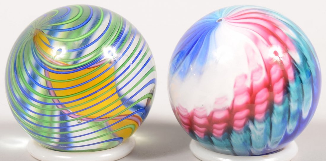 Two Contemporary Handmade Glass Marbles. 1 9/16"di: Two Contemporary Handmade Glass Marbles. 1 9/16"dia. Blue and green swirl with a yellow spiral in center. Along with a 1 9/16"dia. Red, white and blue opaque spiral. Both unsigned.